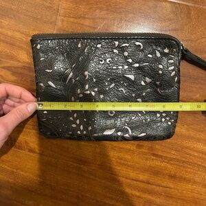 Chic Black Leather Clutch with Intricate Cutout Design